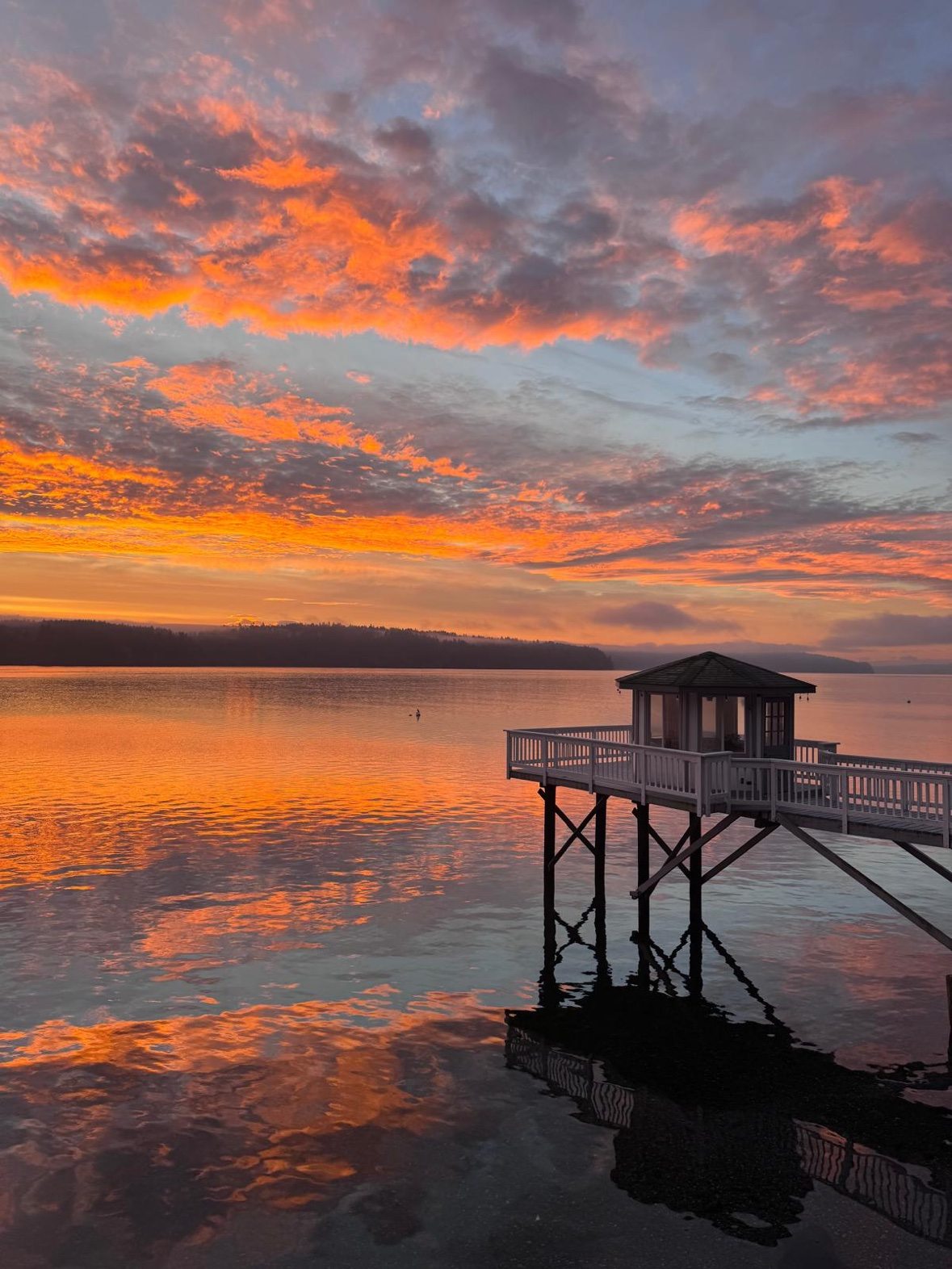 Sunset over the water beside the dock gazebo